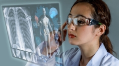 Young female doctor looking at hologram screen. Electronic medical record. Smart glasses. Medical technology concept.